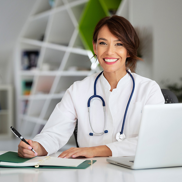 A female doctor doing paperwork. A female doctor doing paperwork.